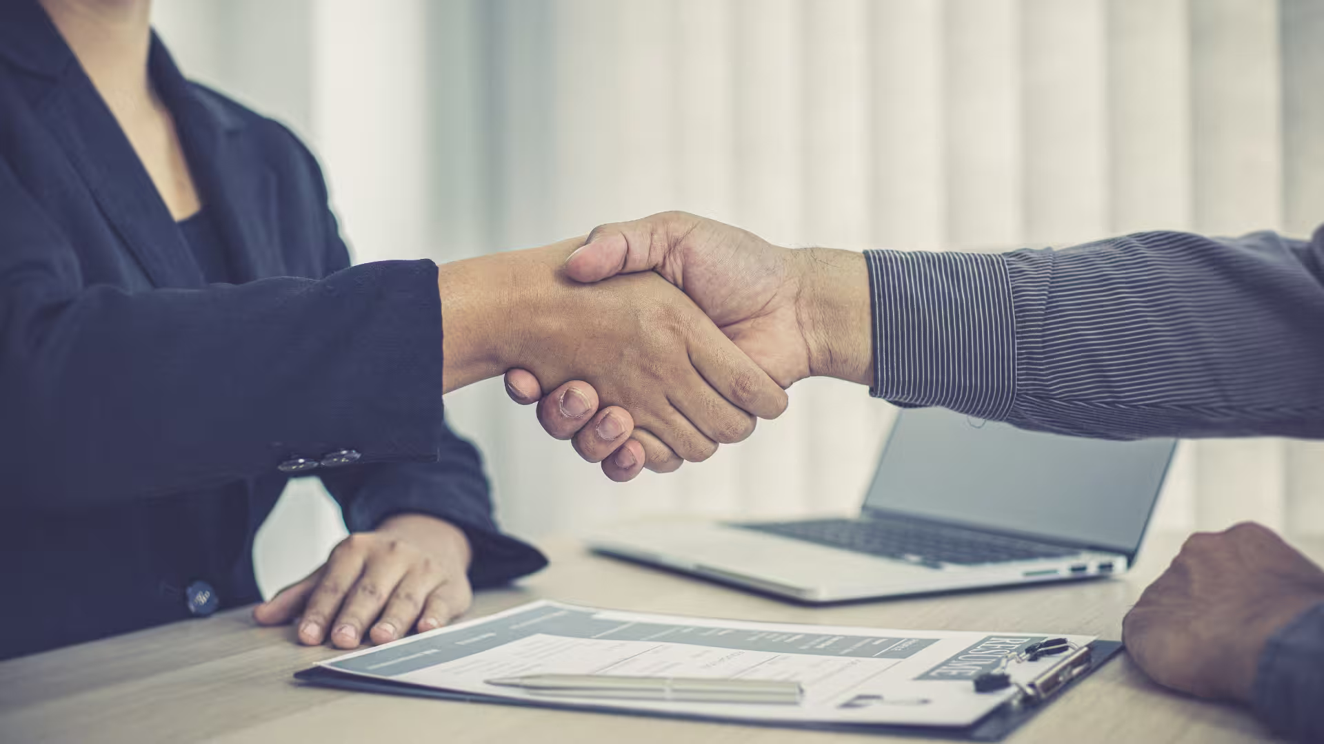 Interviewer and candidate shake hands